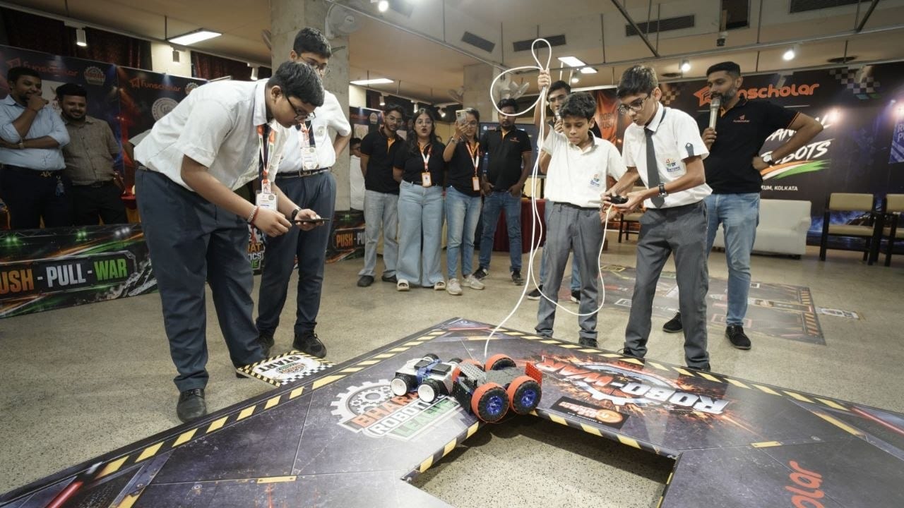 A team guiding their robot across the arena