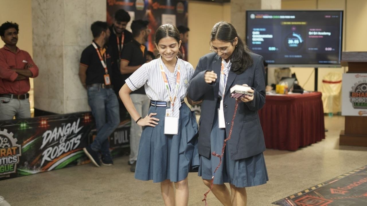 Two students with their robot controller between matches
