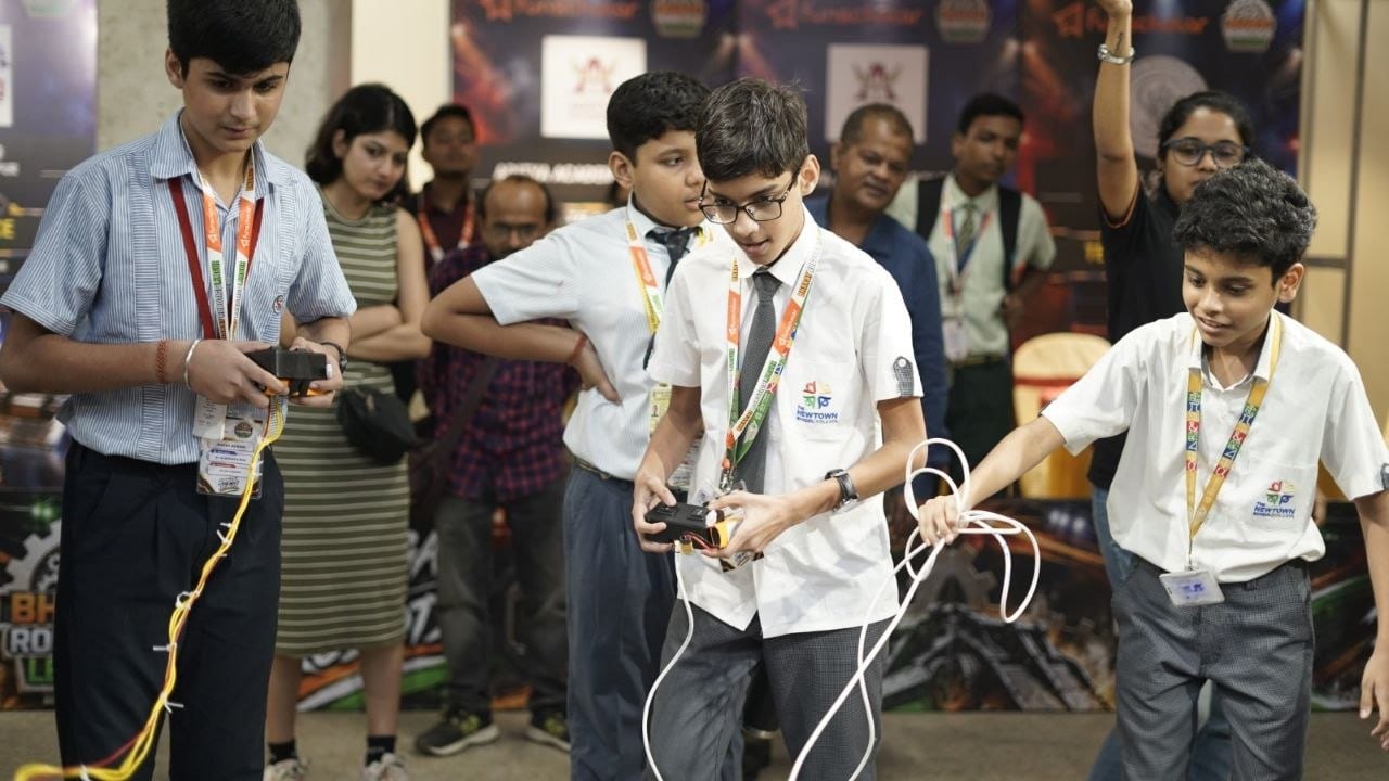Students concentrating on their controllers mid-match